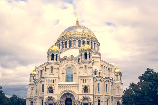 Nicholas the wonderworker's church on Anchor square in kronstadt town Saint Petersburg. Naval christian cathedral church in russia with golden dome, unesco architecture at sunny day warm tone