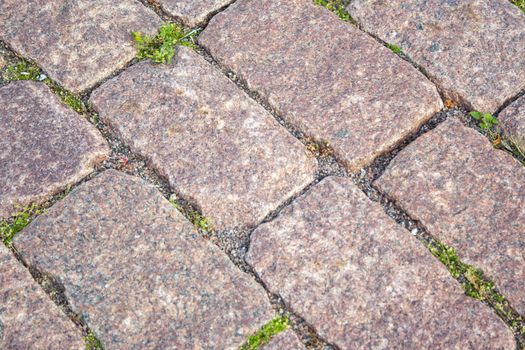 Old aged granite paving stones. Texture of old granite paving stones. The texture of the pavement granite pattern wallpaper for design. Rough texture
