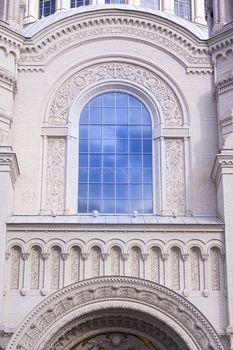 Close up of window on church. Old window on ancient Christian orthodox cathedral. Blue sky in window. Architecture exterior with windows