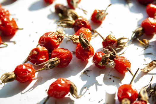 Many rose hips are dried in the sun macro close up. Healthy natural vitamin berries for tea. Natural medical antioxidant