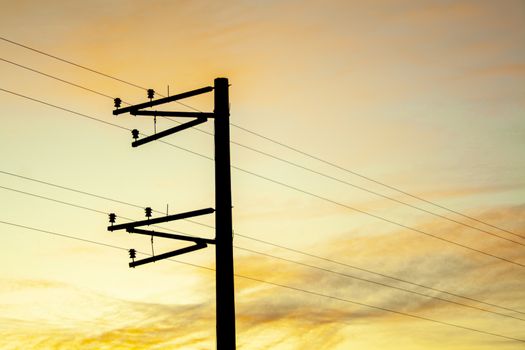 Electric pole shape against the sunset orange sky. Mobile communication, internet. electricity concept