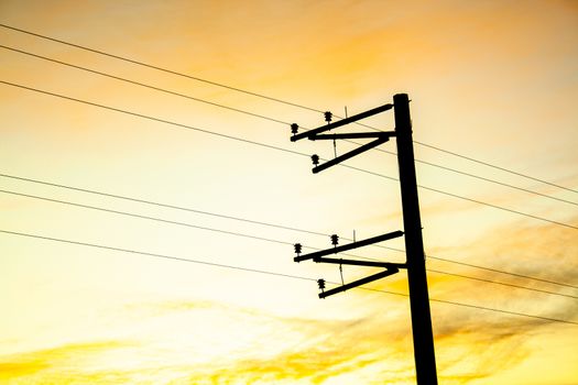 Electric pole shape against the sunset orange sky. Mobile communication, internet. electricity concept