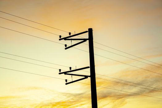 Electric pole shape against the sunset orange sky. Mobile communication, internet. electricity concept