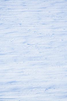 Winter frozen surface of snow field with snowdrifts at sunny winter day