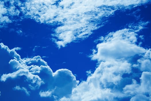 Huge white clouds in trendy blue 2020 color on the sunny day background