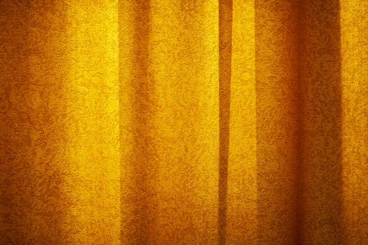 Red curtain background in sunset light. Curtain cloth texture dark