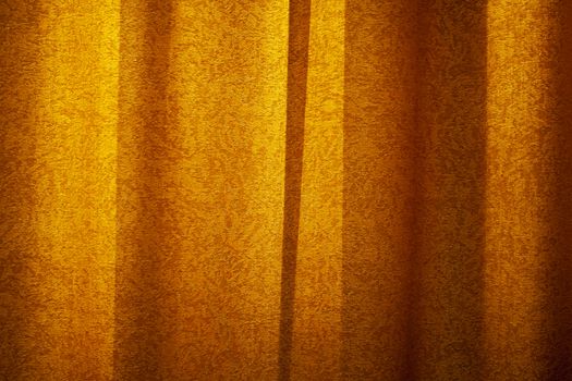 Red curtain background in sunset light. Curtain cloth texture dark