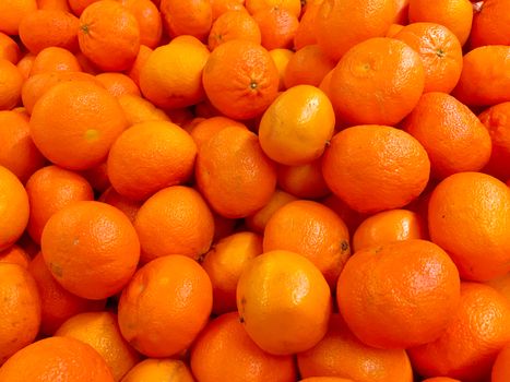 Fresh tangerines on a market stall. Fresh mandarin oranges fruit or tangerines as background