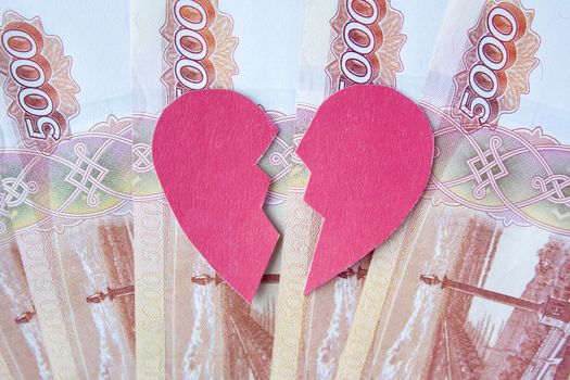 Valentine heart broken in two on roubles banknotes. Love cannot be forced. Marriage of convenience. Love money more than people.

