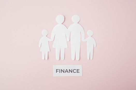 paper family cut out on bright pink background, family home, foster care, family mental health, budget and money concept. Paper family with phrase quote finance 