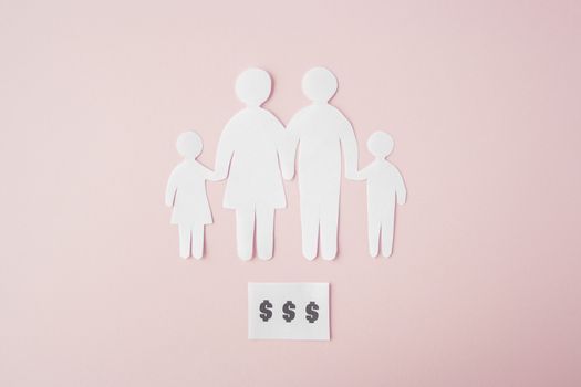 paper family cut out on bright pink background, family home, foster care, family mental health, budget and money concept. Paper family with phrase quote Dollars 