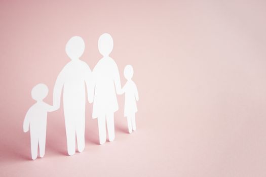 paper family cut out on bright pink background, family home, foster care, family mental health, homeschool education concept. 