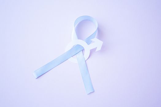 Prostate cancer awareness blue ribbon with white paper male sign mars arrow on pink background. Men healthcare concept, men carcinoma symbol.