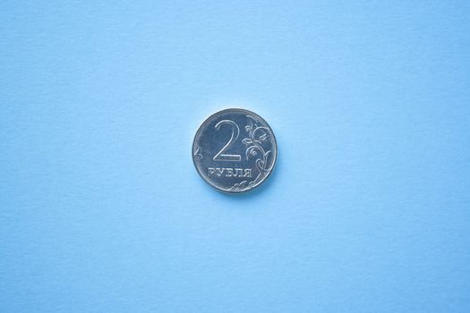 Coin two rouble on bright blue background. ruble depreciation. Rouble to dollar