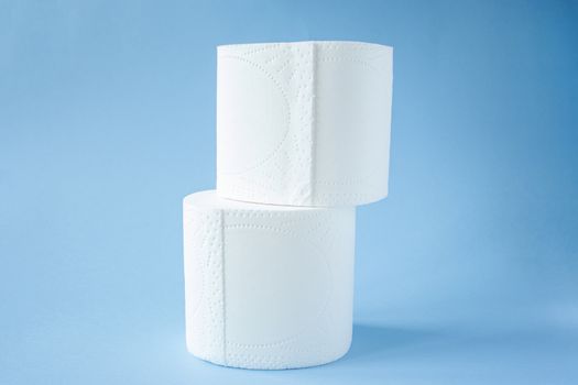 two Toilet paper roll on a blue background top view. Toilet paper purchase due to kronavirus concept. Personal hygiene and stopping the spread of the virus. Cleanliness, Hygiene, Sterility