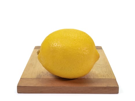 The close up of  fresh yellow lemon organic food on small wooden board on white background.