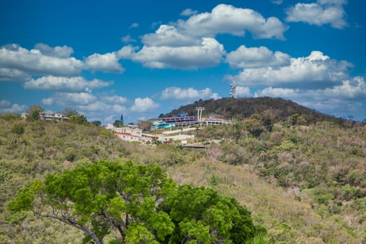 Skylift and buildings on a green tropical hillside on St Thomas