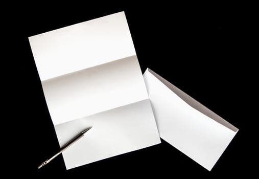 blank of letter paper and white envelope with pen Isolated on black background
