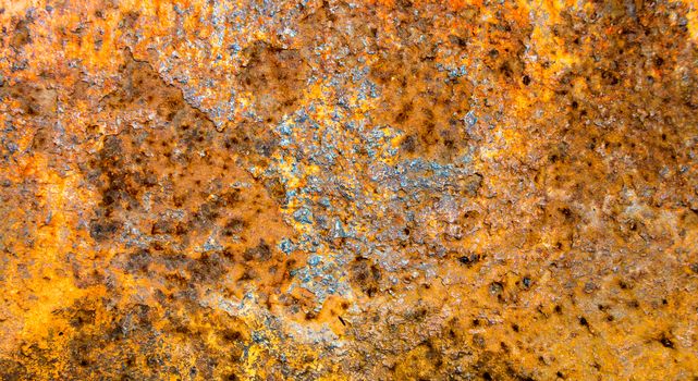 Detailed surface texture of orange rust on old steel plate as background with space for text, close up view of grunge rusty metal surface industrial wallpaper