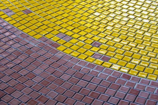 Yellow, White and Brown tiles on the floor of hall