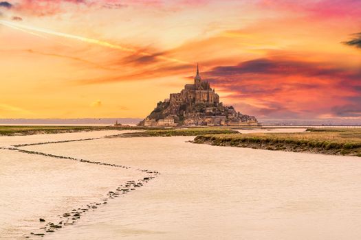 Beautiful view of famous historic Le Mont Saint-Michel tidal island, Normandy, France in beautiful evening twilight at dusk