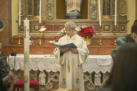 Priest celebrates the liturgy in a Catholic church in Italy