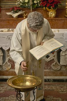 Priest celebrates the liturgy in a Catholic church in Italy