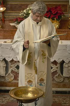 Priest celebrates the liturgy in a Catholic church in Italy