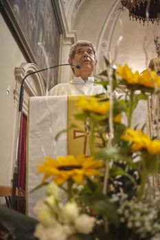 Priest celebrates the liturgy in a Catholic church in Italy