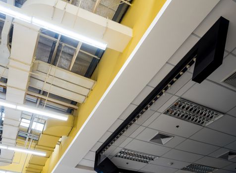 Ceiling mounted Lamps pipes and air ducts and communication system in the hall