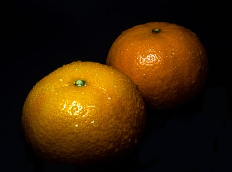 Close-up of Water droplet on glossy surface of freshness orange on black background