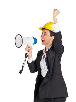 A businesswoman wearing a yellow construction helmet shouted at a megaphone while raising her fist over her head. Portrait on white background with studio light.