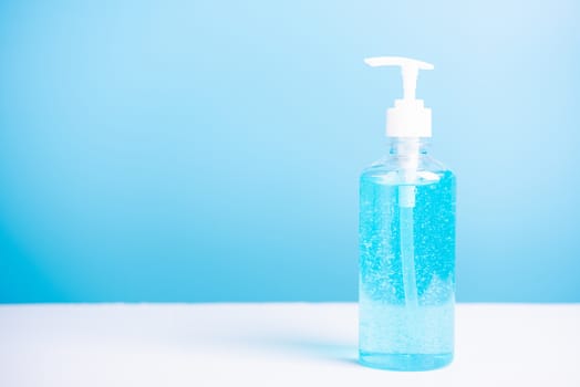 Plastic dispenser sanitizer alcohol gel pump bottle for washing hand hygiene prevention of coronavirus virus studio shot on blue background