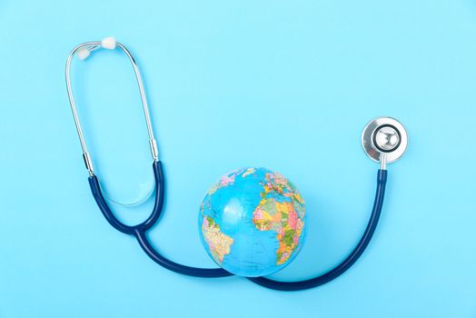 World health day concept, Stethoscope, globe on blue background with copy space. Global health care