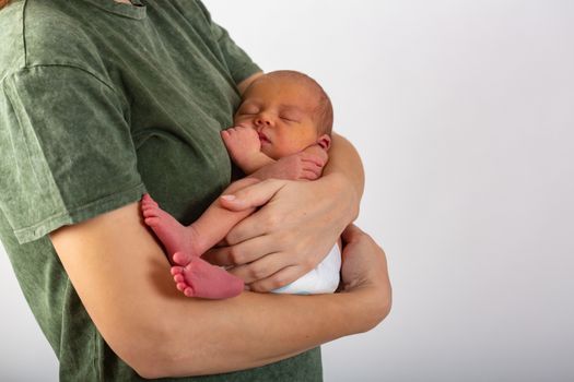 Beautiful new born baby resting on mom's hands.