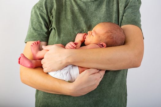 Beautiful new born baby resting on mom's hands.