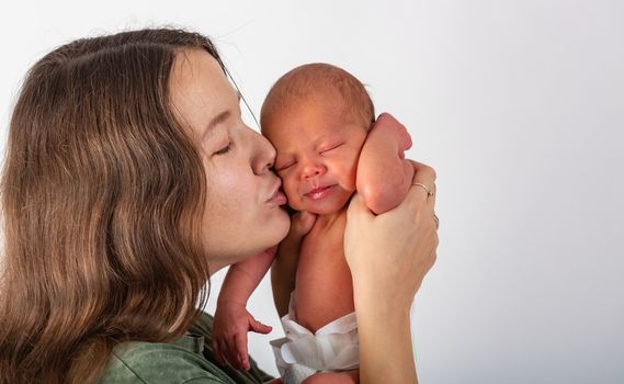 Mother and Baby kissing and hugging. Happy Family.