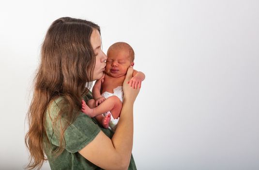 Mother and Baby kissing and hugging. Happy Family.