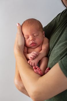 Beautiful new born baby resting on mom's hands.