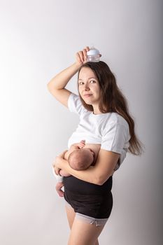 A mother breastfeeds a baby, not a bottle. Natural feeding concept