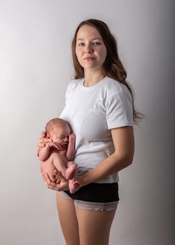 Pretty little thing. Mother holding her baby. Close up