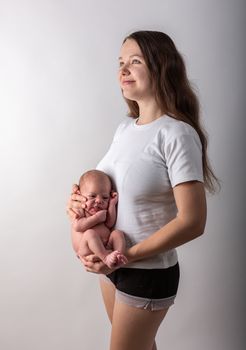 Pretty little thing. Mother holding her baby. Close up