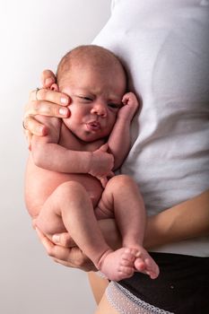 Beautiful new born baby resting on mom's hands.