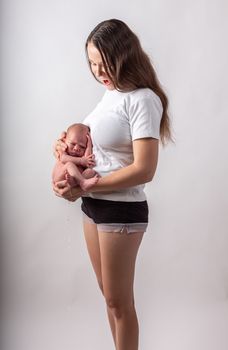 Pretty little thing. Mother holding her baby. Close up