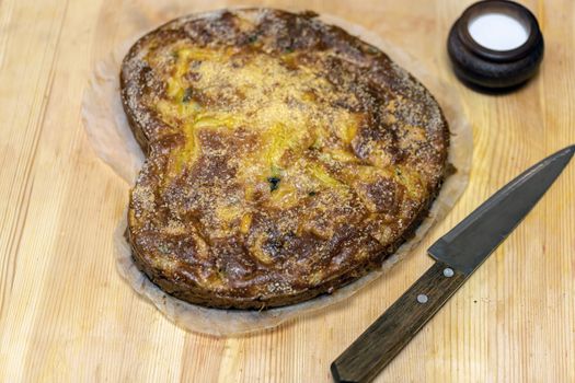 Homemade yeast-free cake on kefir with a filling of canned fish and potatoes, close-up. A hearty dish for a Flexitarian