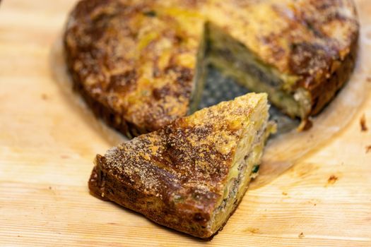 Homemade yeast-free cake on kefir with a filling of canned fish and potatoes, close-up. A hearty dish for a Flexitarian