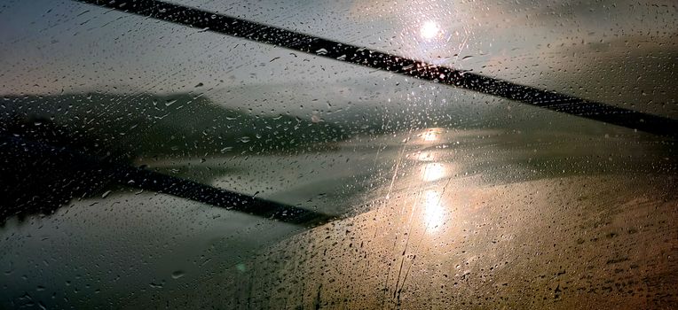 Vibrant abstract of dew covered window against a rising sun