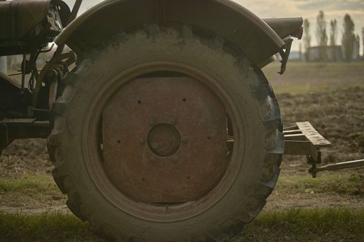 Wheel of the agricultural tractor during a work day in the fields