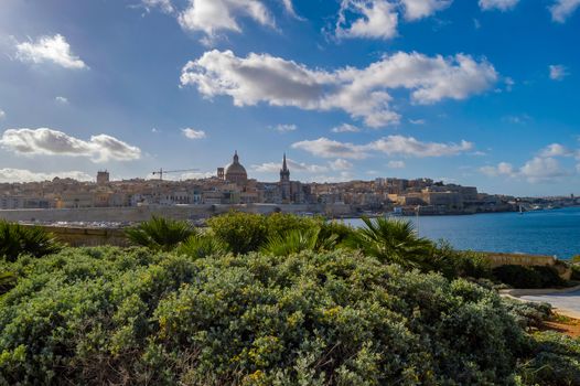 Panoramic view of Valletta Skyline at beautiful sunset from Sliema with churches of Our Lady of Mount Carmel and St. Paul's Anglican Pro-Cathedral, Valletta, Capital city of Malta
