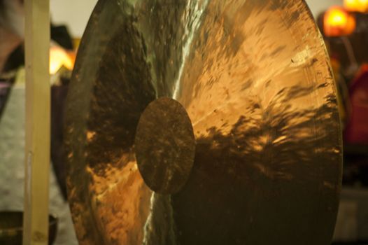 Golden oriental gong with reflection on metal material